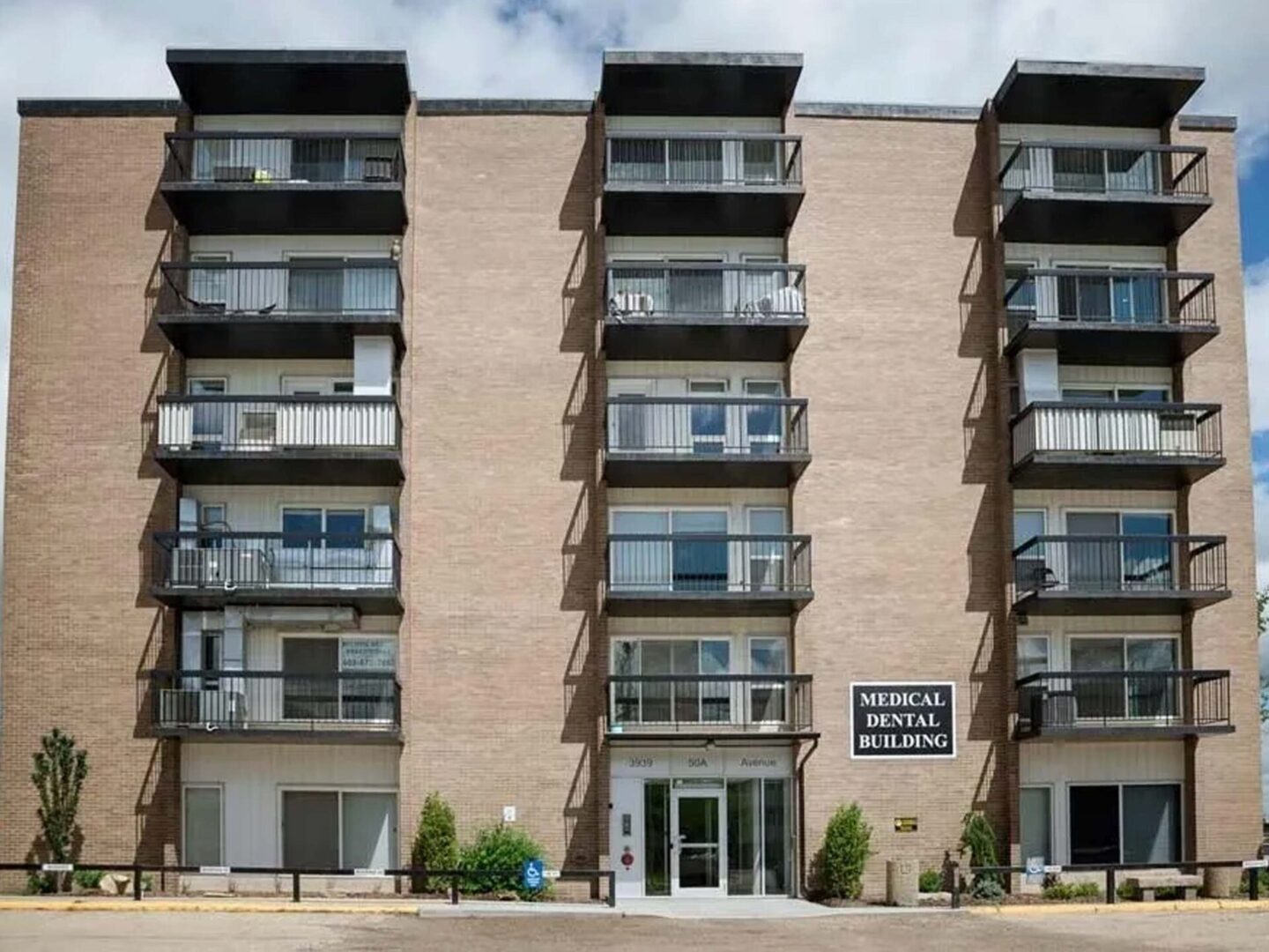 A large brick building with balconies and windows.